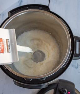 adding milk to the soon to be yogurt in the instant pot.