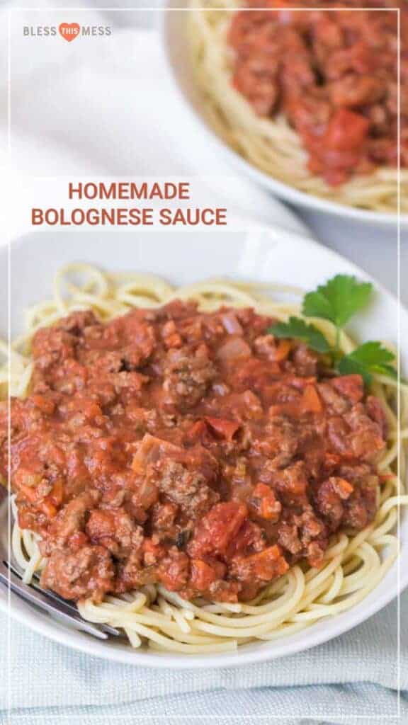 Homemade bolognese sauce on round white plate with garnish