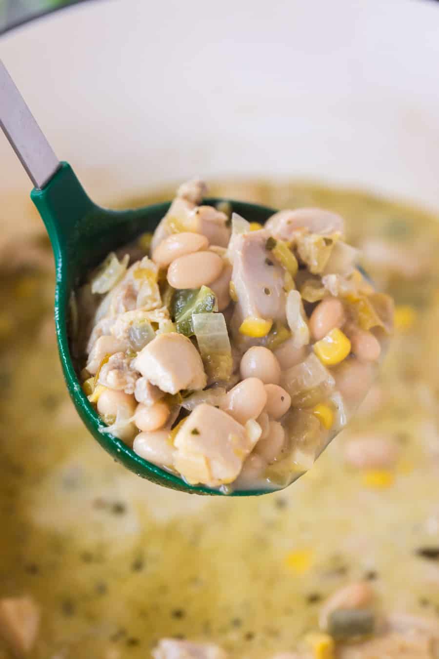 green ladle full of white bean chicken chili 