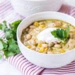 round white bowl with white bean chicken chili on red striped towel