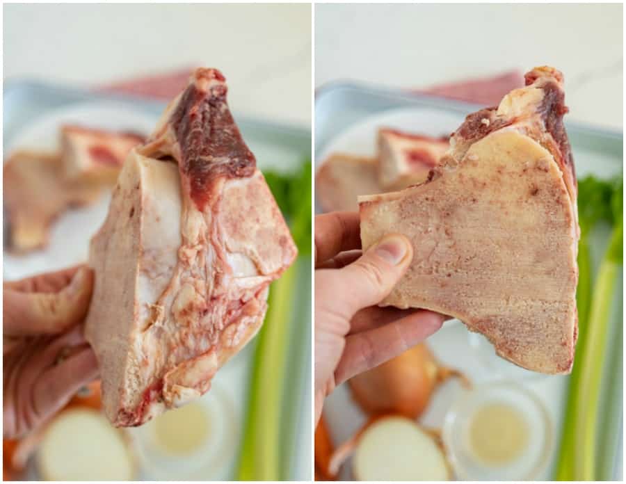 woman holding beef bones over tray of vegetables