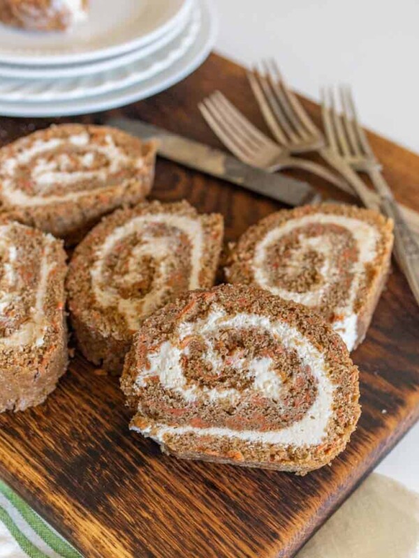 whole wheat flour carrot cake rolls with icing inside cut open on a cutting board