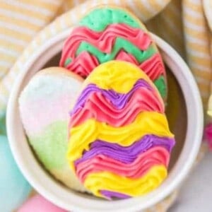 easter sugar cookies in a bowl with colorful icing