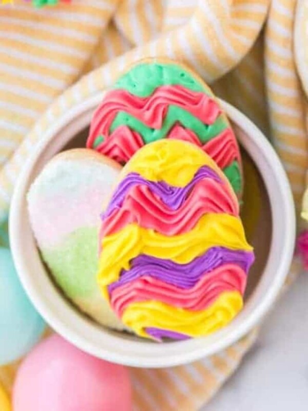 easter sugar cookies in a bowl with colorful icing