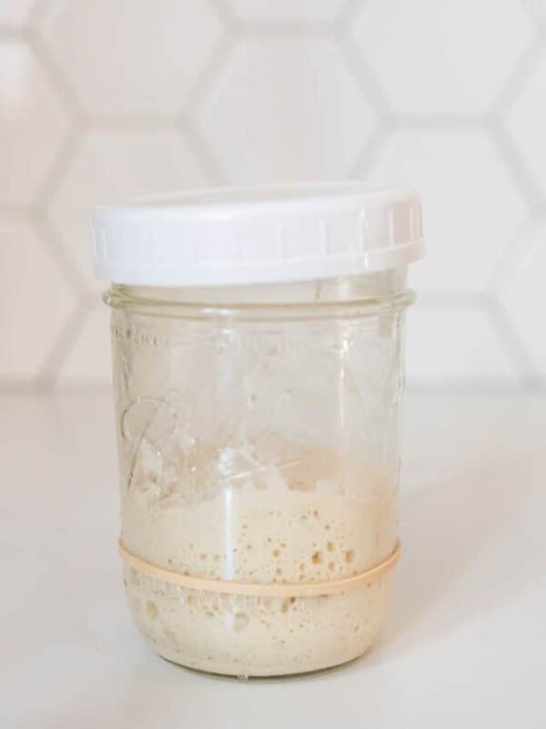 a jar of sourdough bubbling starter