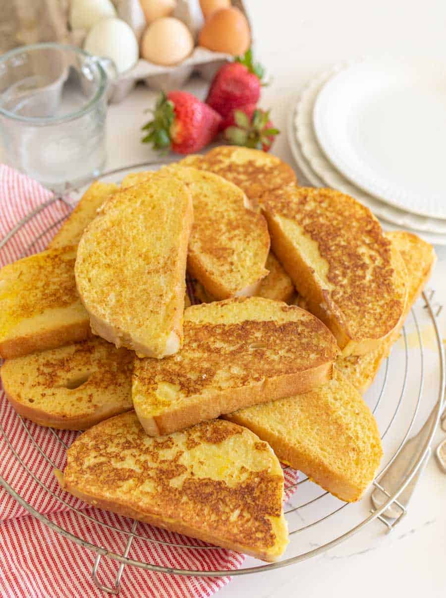 french toast on cooling rack on top of red and white striped towel