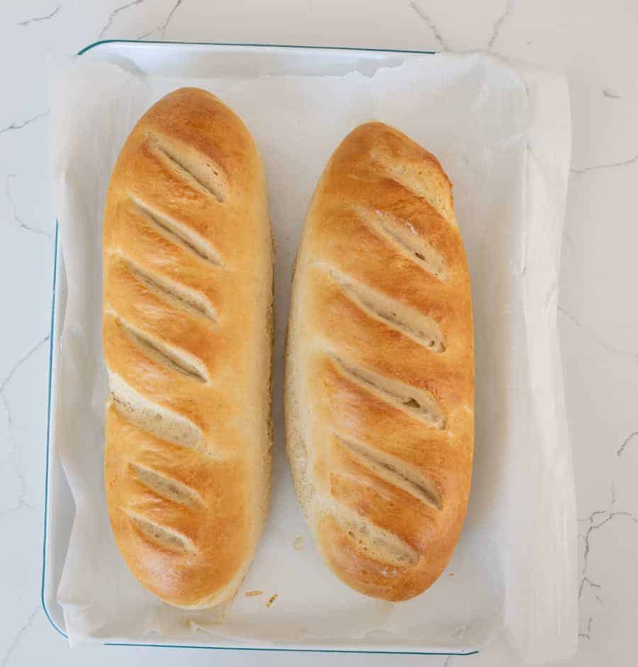two loaves of french bread on parchment paper 
