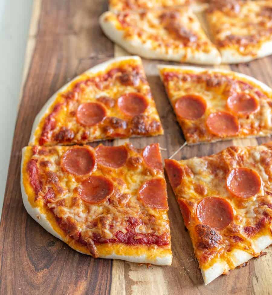 pepperoni sourdough pizza on wood cutting board