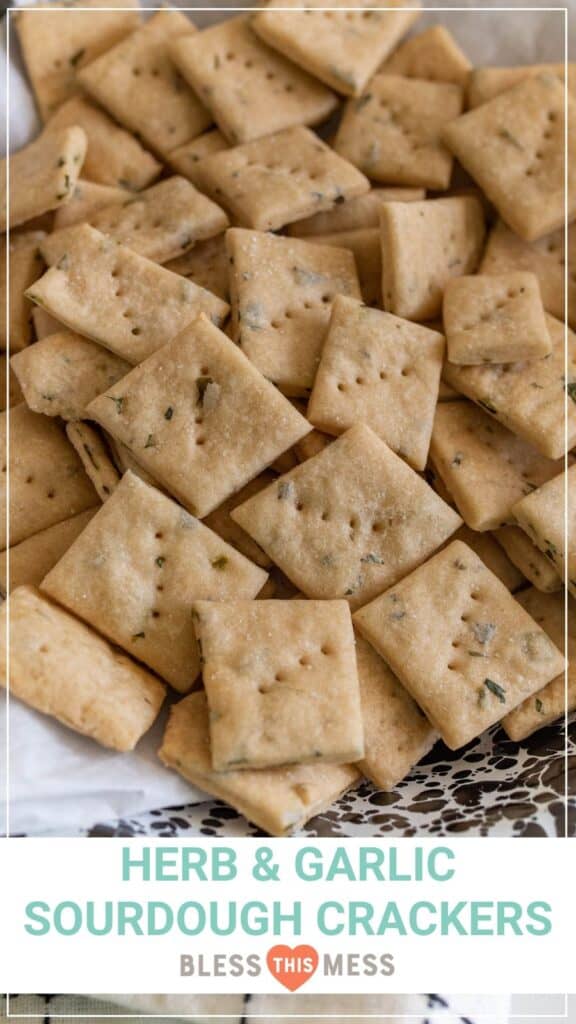 herb and garlic sourdough crackers in black and white bowl