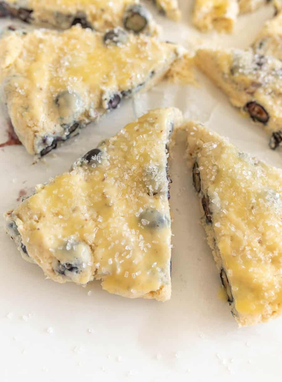 closeup of cut blueberry scones on parchment