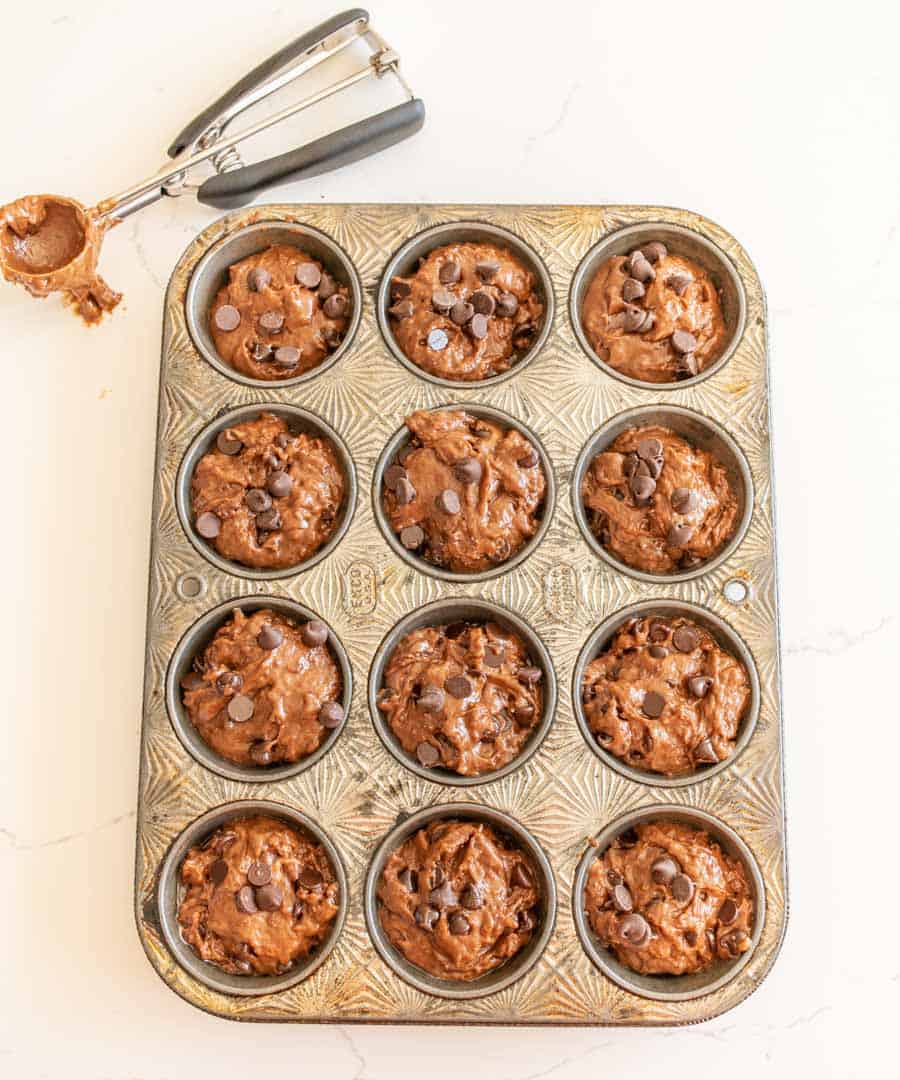 sourdough muffin dough in the muffin tin before baking