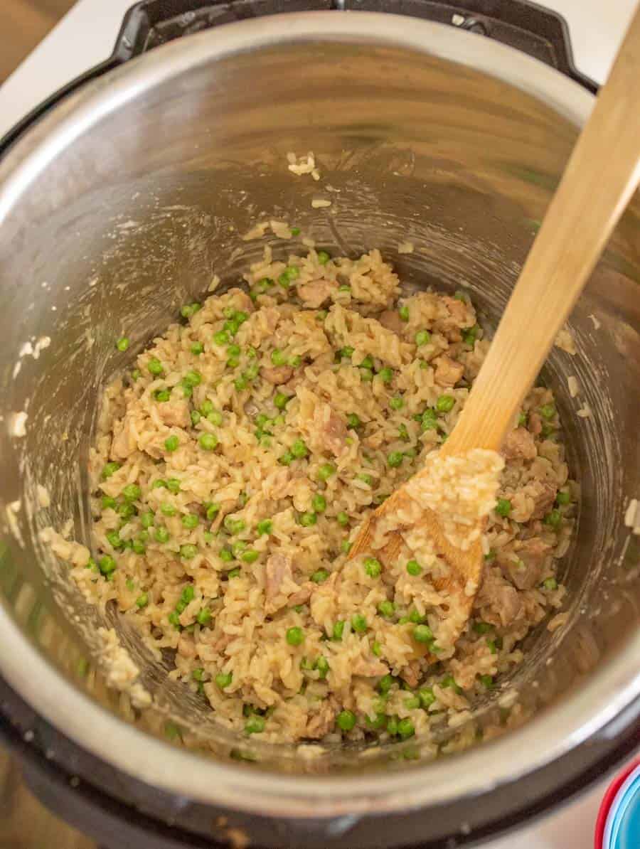 instant pot chicken rice and vegetables with wooden spoon in instant pot