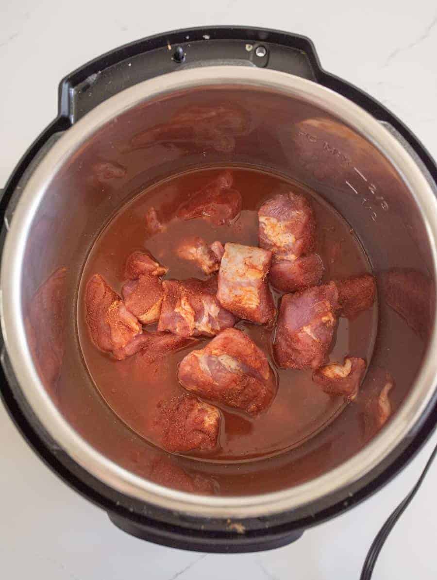 raw pork and sauce in instant pot before cooking