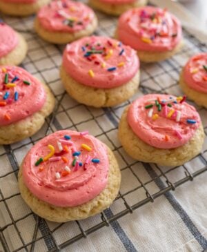 pink frosted cookie on cooling rack