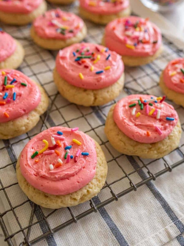 pink frosted cookie on cooling rack
