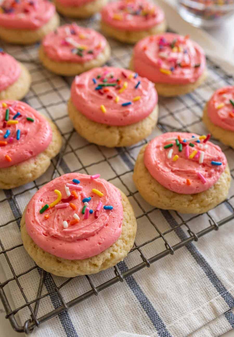 pink frosted cookie on cooling rack