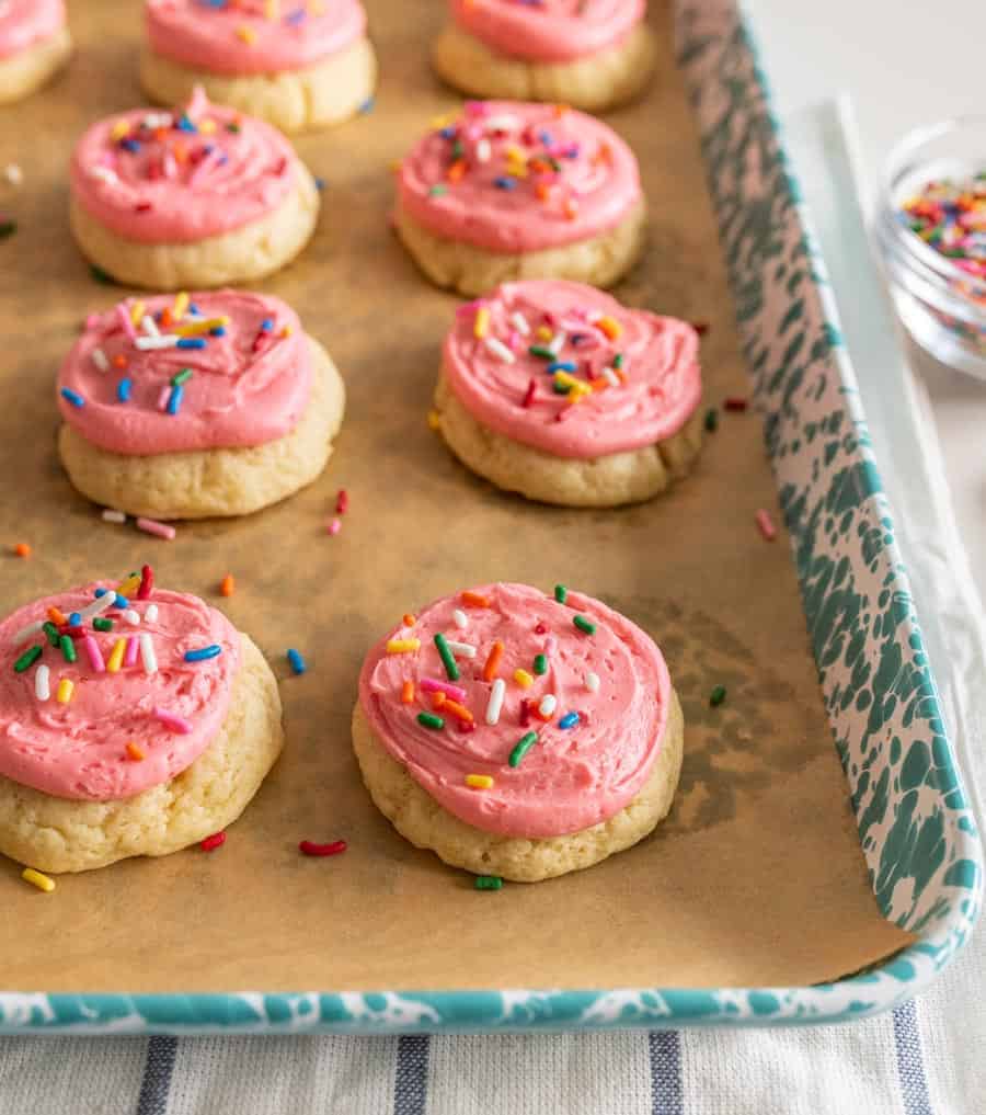 cookies on tray with pink frosting