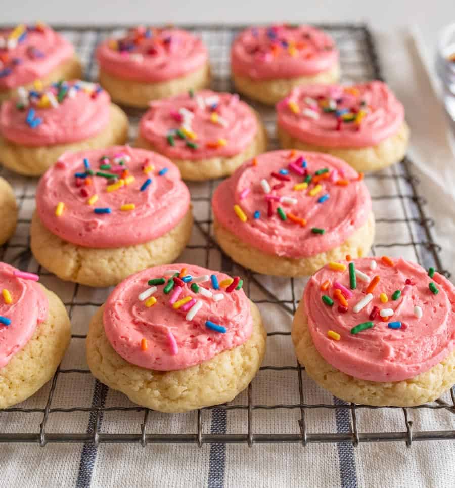 pink frosted cookies on tray