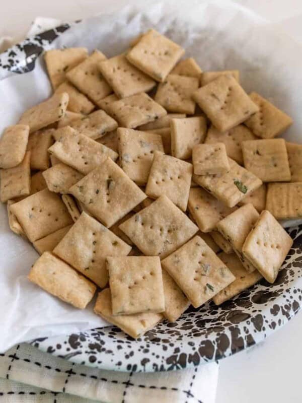 close up of baked sourdough crackers in a serving dish.