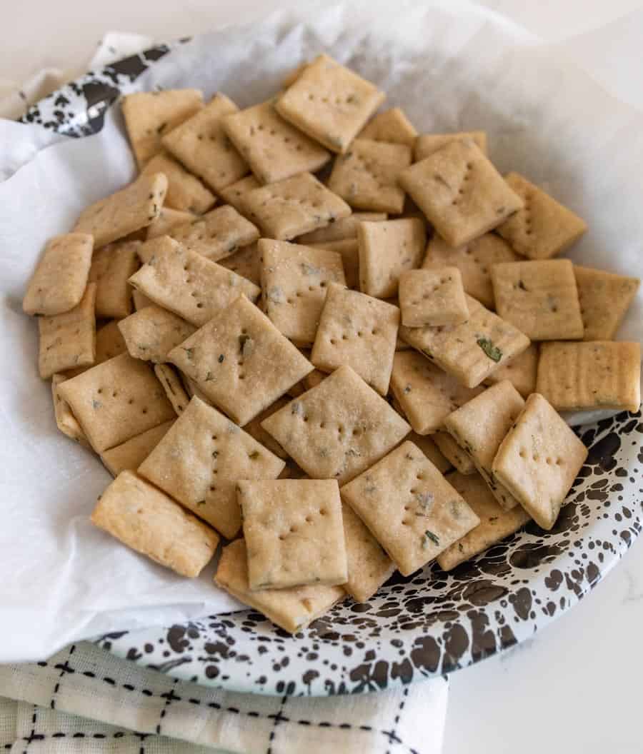 close up of baked sourdough crackers in a serving dish