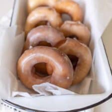 glazed donuts resting a pan to serve