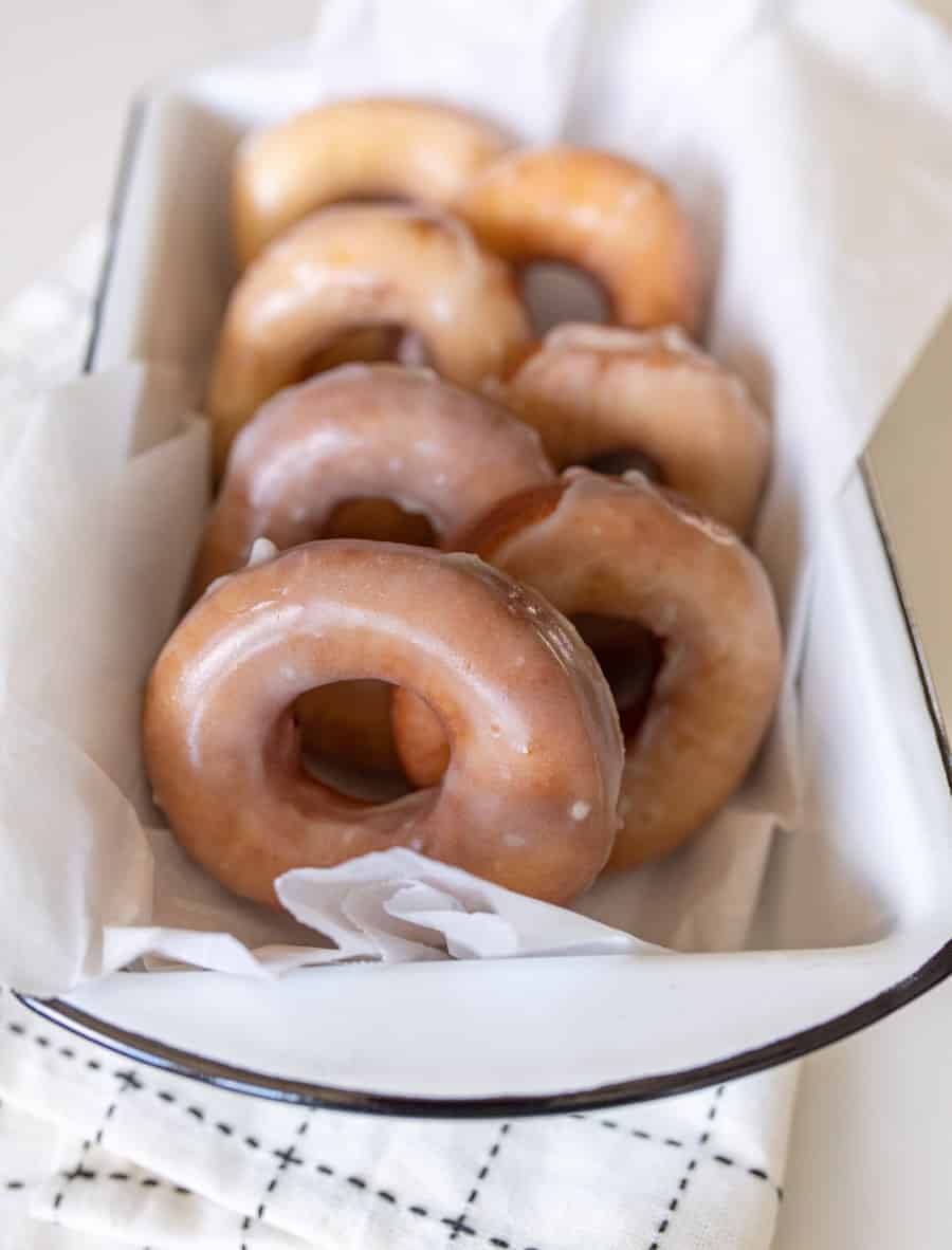 glazed donuts resting a pan to serve