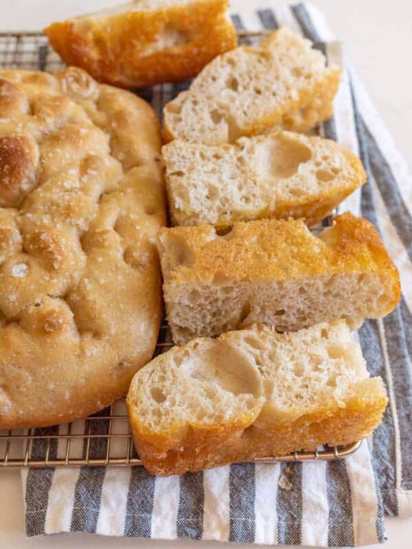 baked sourdough focaccia bread baked and sliced on cooling rack