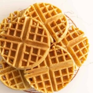 sourdough waffles on a cooking rack made with a sourdough waffle recipe.