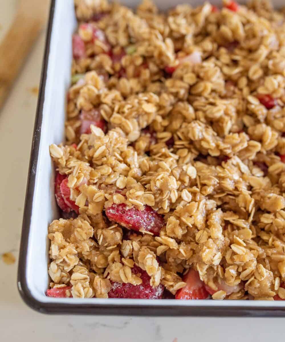 strawberry rhubarb crisp with topping in pan before baking