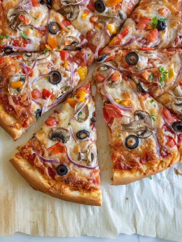 closeup of homemade veggie pizza on parchment