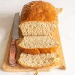loaf of sliced bread on cutting board with knife
