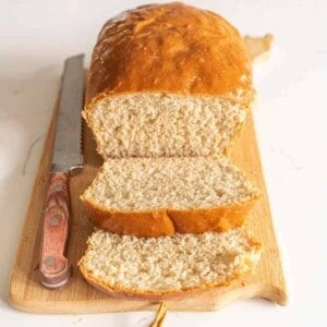 loaf of sliced bread on cutting board with knife