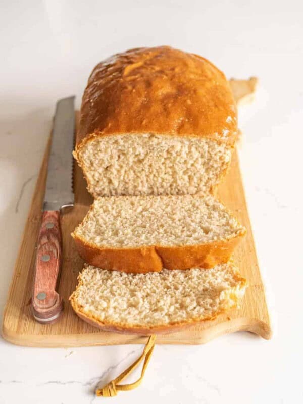 loaf of sliced bread on cutting board with knife