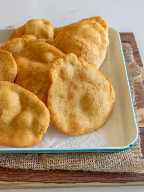 cooked fry bread on a rimmed sheet cooling