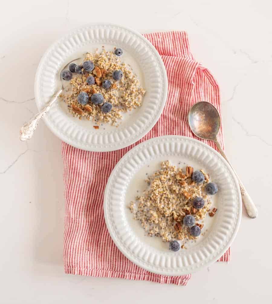 steel cut oats with fruit in white bowls