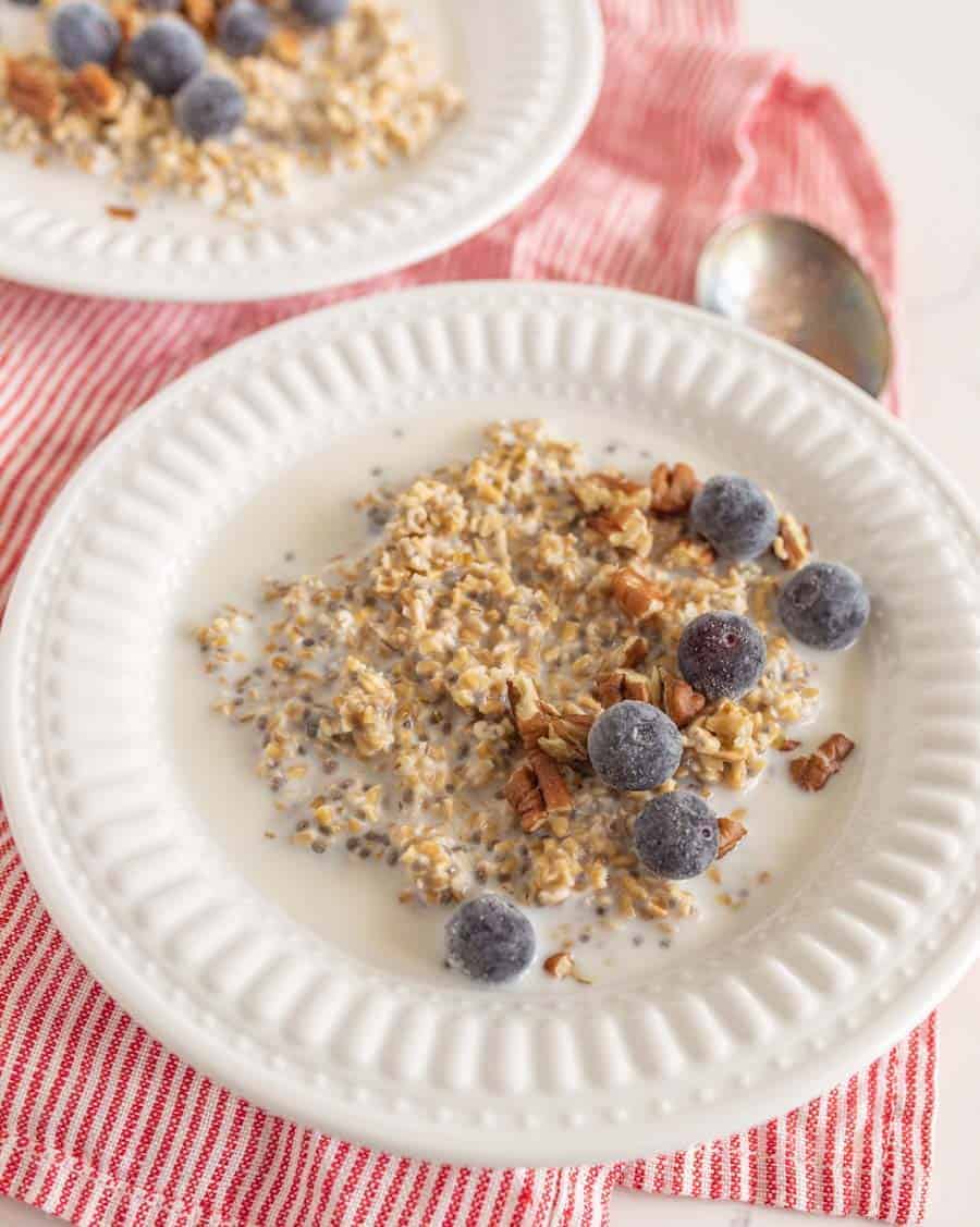 closeup of overnight steel cut oats with blueberries in white bowl