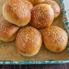 sourdough burger buns on a sheet after baking