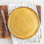 round pan of sourdough cornbread on cutting board