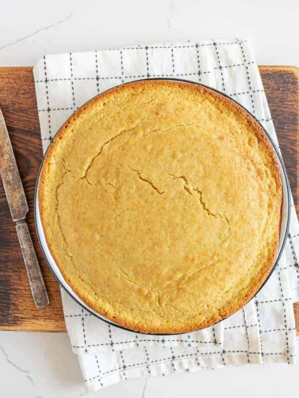 round pan of sourdough cornbread on cutting board