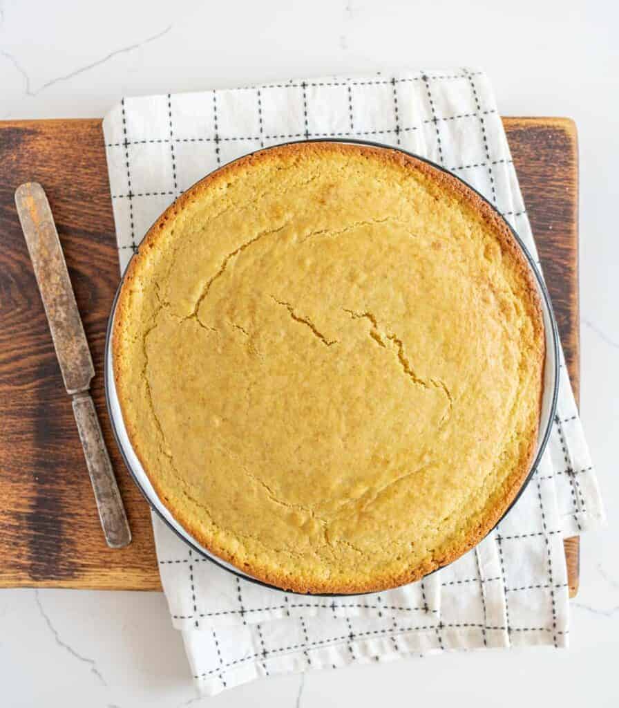 round pan of sourdough cornbread on cutting board