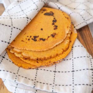 stack of tortillas in kitchen towel
