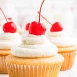 cluster of close up cherry chip cupcakes with maraschino cherries on top of each on