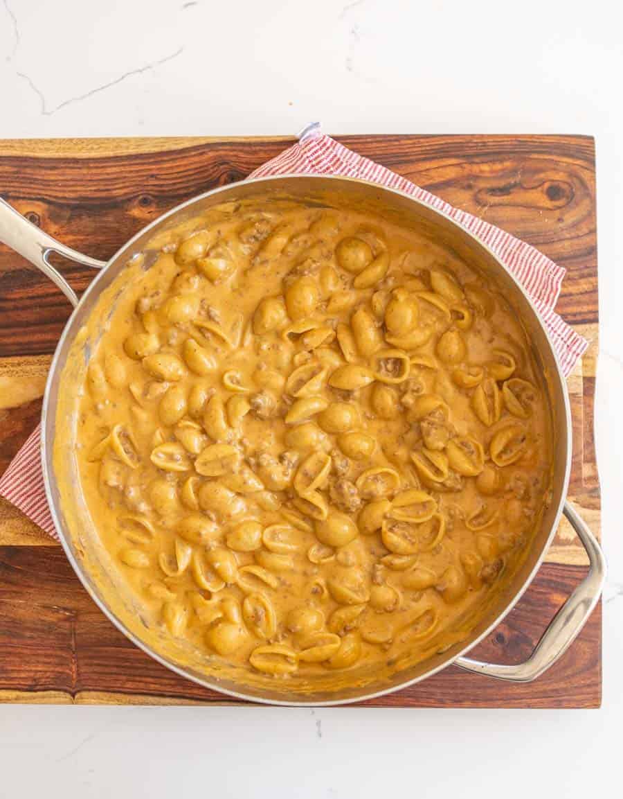 cheesy yellow pasta and beed in a skillet