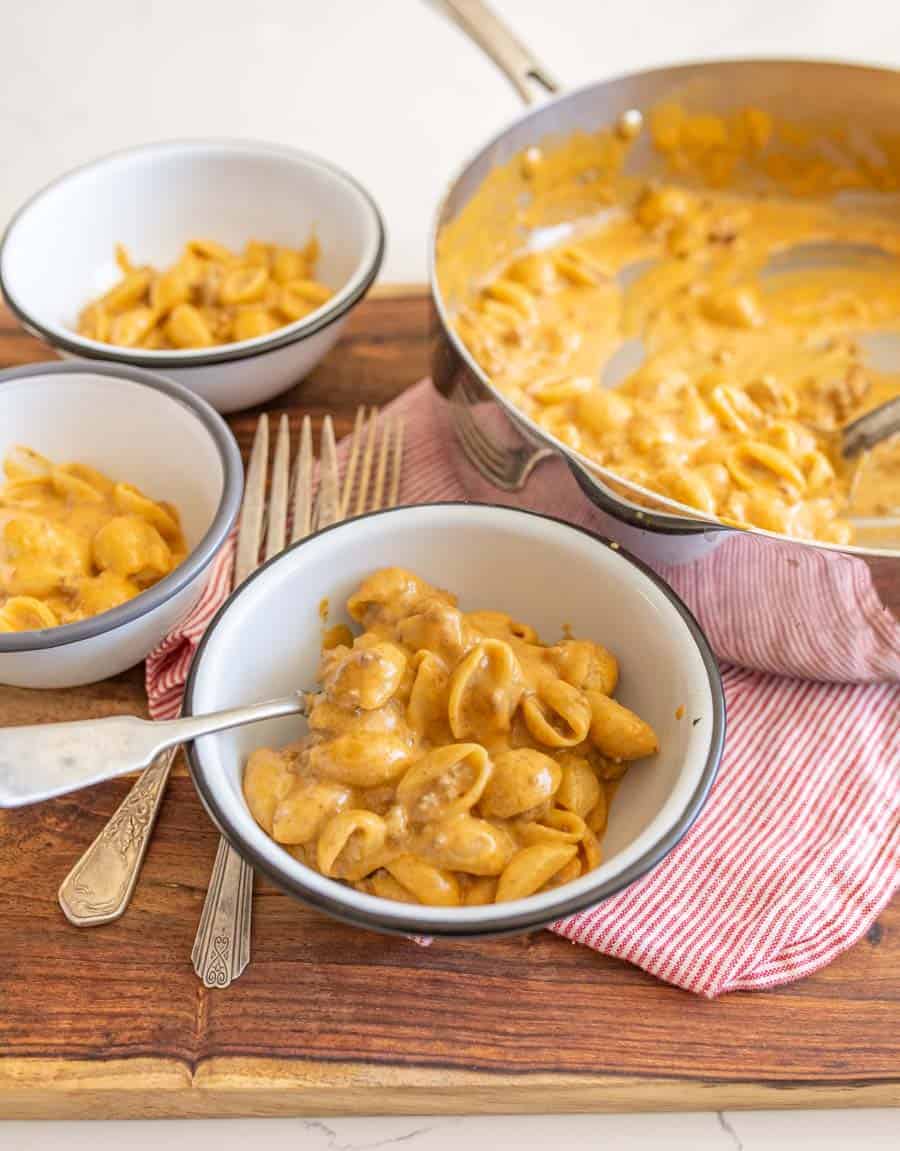 Hamburger helper in a white bowl with spoon.