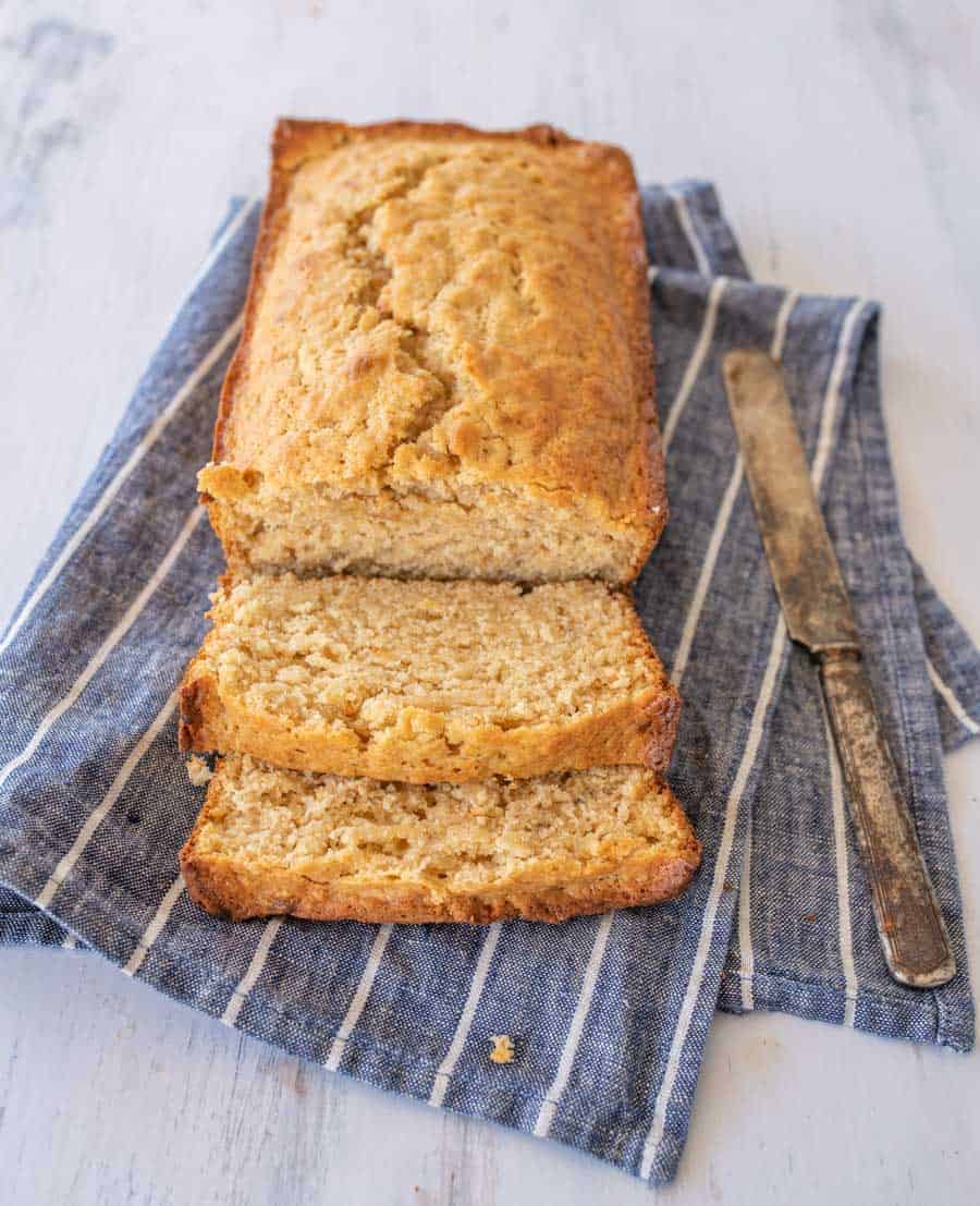 Sliced sourdough banana bread on blue towel.