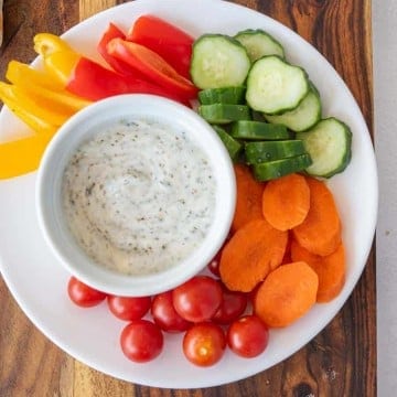 plate of colorful veggies with dip in a bowl