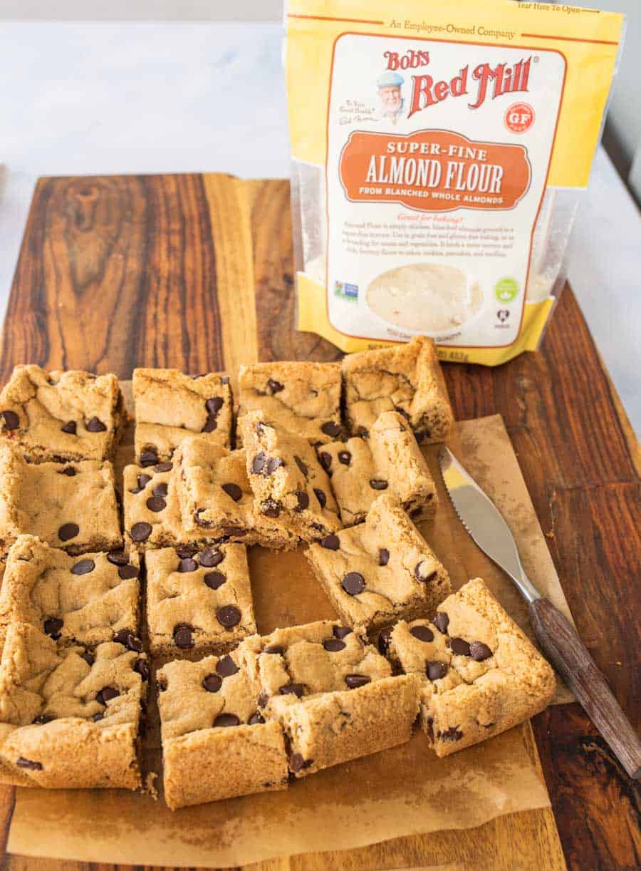 baked chocolate chip cookies bars with bag of almond flour in background