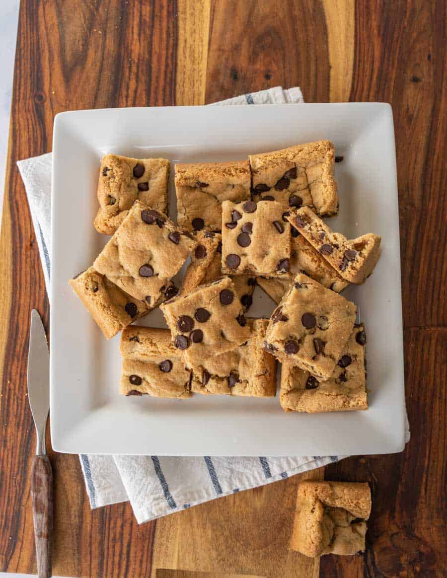 baked and sliced almond flour chocolate chip cookies bars on white serving platter
