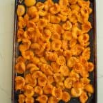 halved apricots on baking sheet.