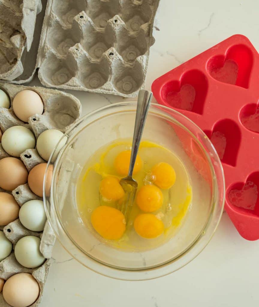 raw eggs before being scrambled in glass bowl